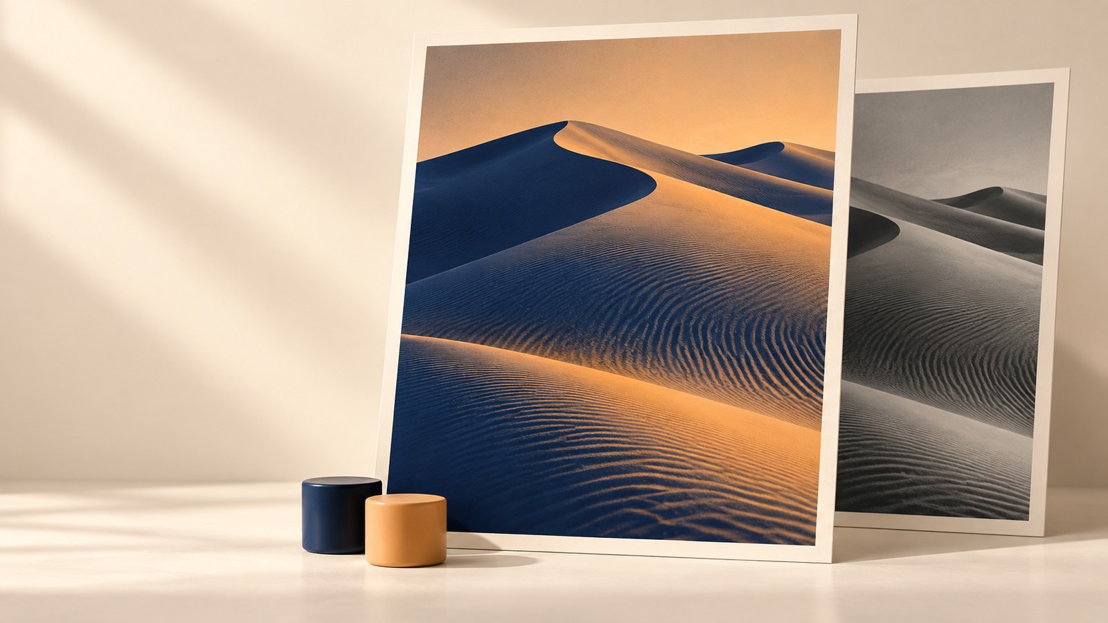 A navy and apricot dune photograph stands in front of a grayscale dune print, with two matching color samples below.